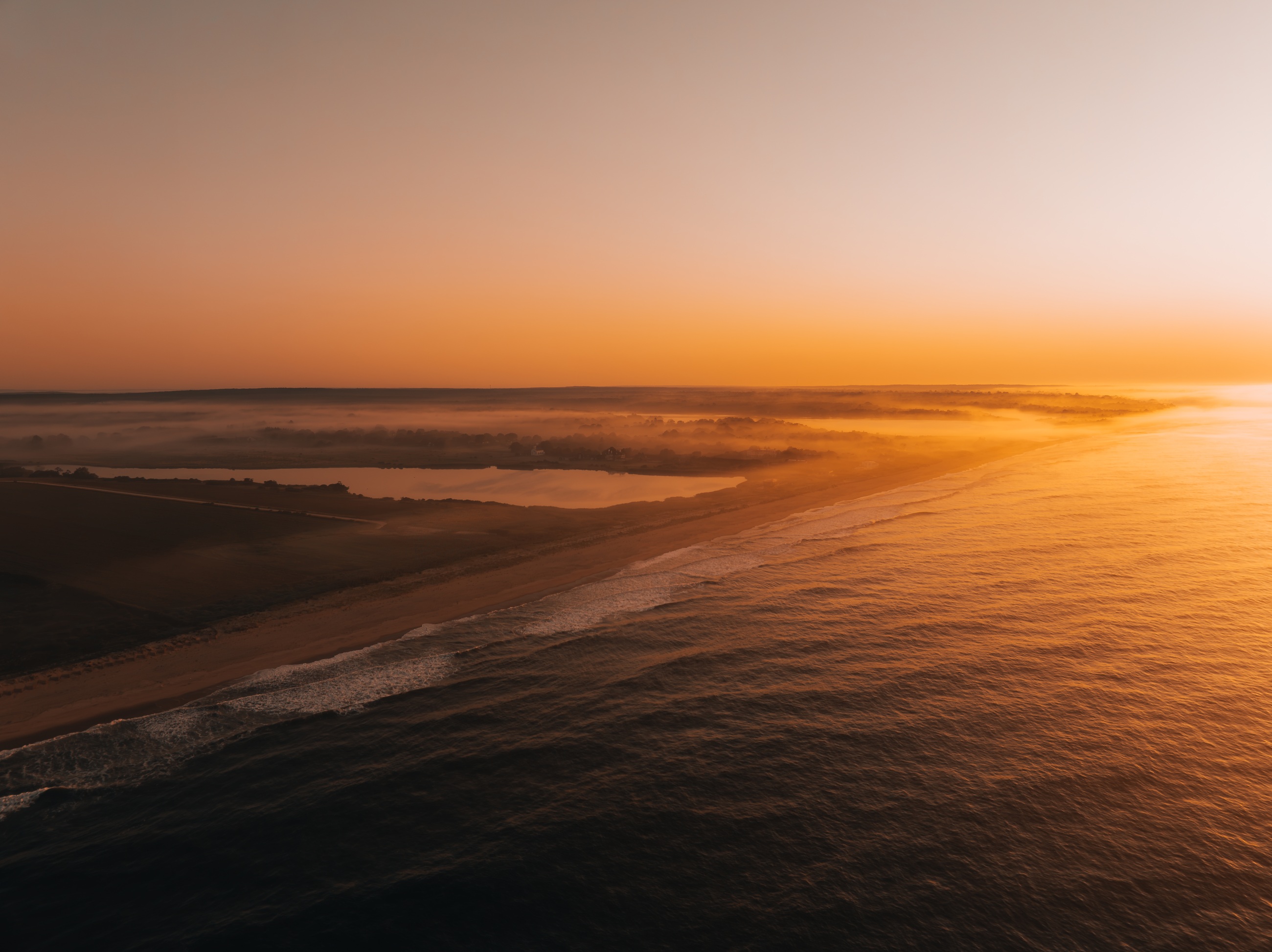 Sunset over a sandy coastline
